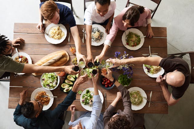 a large family dinner with everyone cheersing