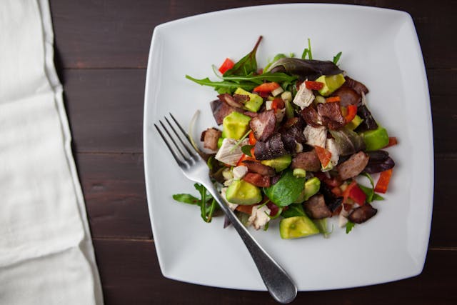 a plate of salad with a fork