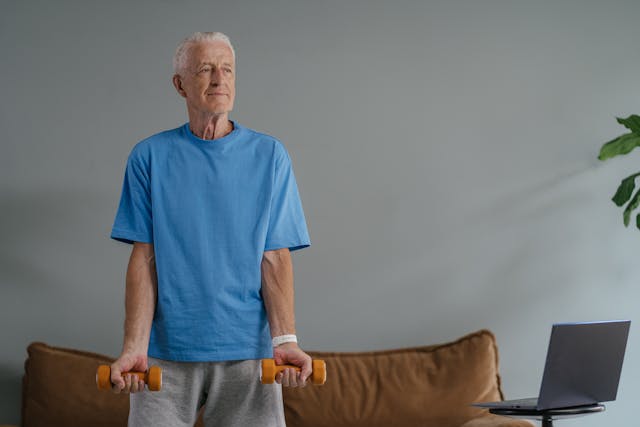 an older man lifting orange weights