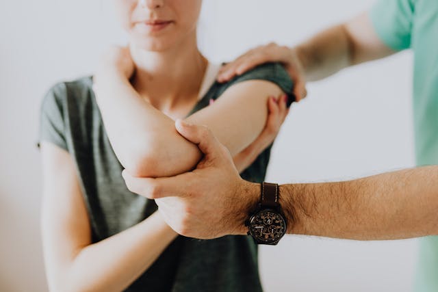 a doctor helping a patient stretch