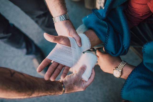 helping someone wrap their hand