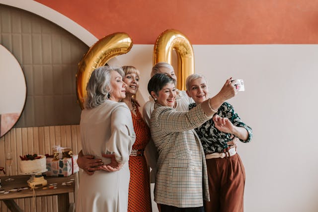 a group of older women taking a selfie