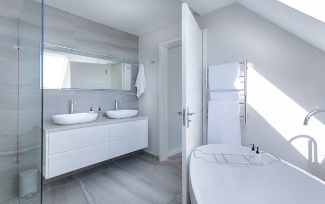 a bathroom with two sinks and a tub