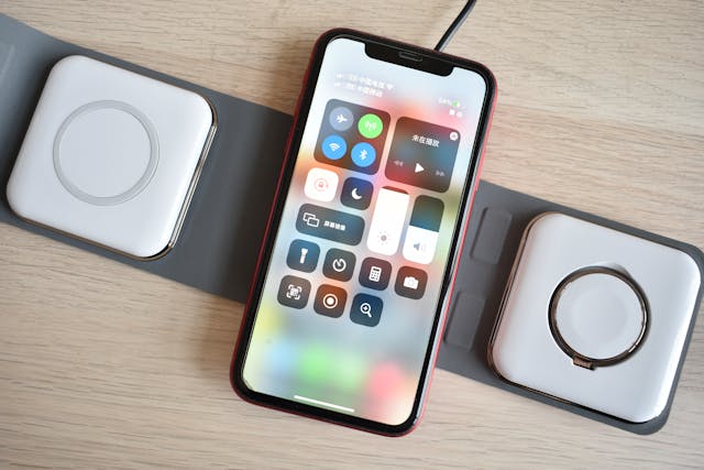 a phone sitting on a wireless charger with 3 pads