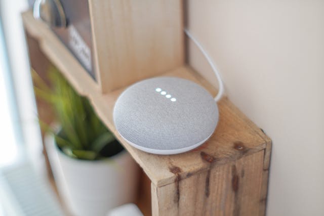 a smart home device on a brown shelf