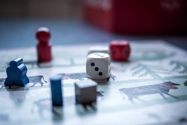 a board game with several pieces and a dice
